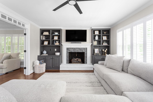 213 Brompton Ct, Burlington, NC 27215 - living area with ceiling fan, ornamental molding, built in shelves, wood finished floors, and a stone fireplace