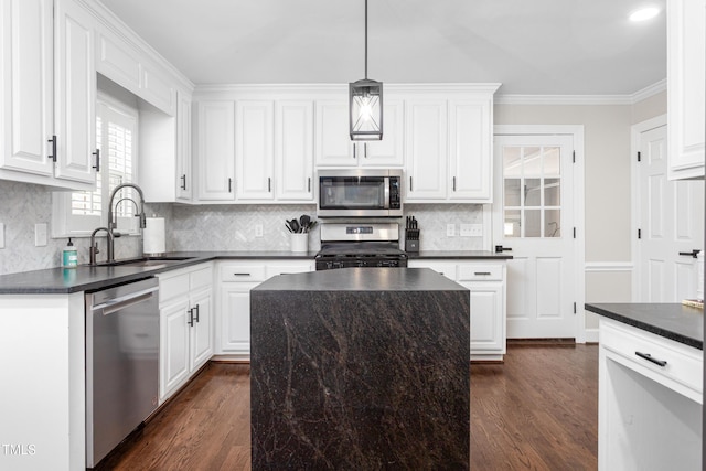 213 Brompton Ct, Burlington, NC 27215 - kitchen with appliances with stainless steel finishes, dark countertops, dark wood-type flooring, white cabinets, and crown molding