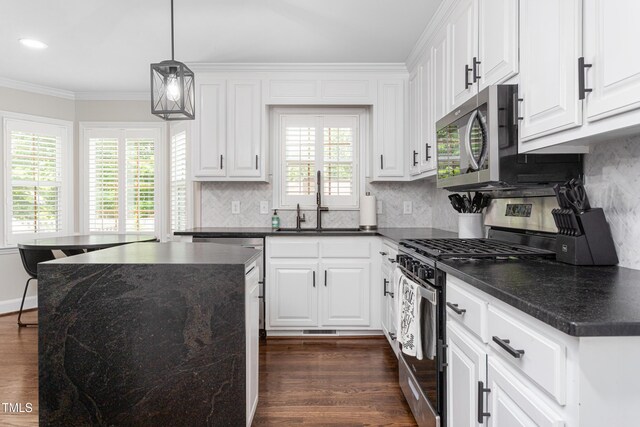 213 Brompton Ct, Burlington, NC 27215 - kitchen with stainless steel appliances, crown molding, dark wood-type flooring, and decorative backsplash