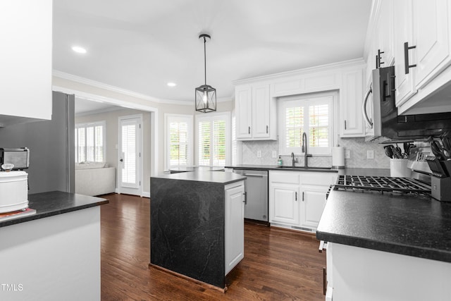 213 Brompton Ct, Burlington, NC 27215 - kitchen featuring appliances with stainless steel finishes, dark countertops, ornamental molding, white cabinets, and tasteful backsplash