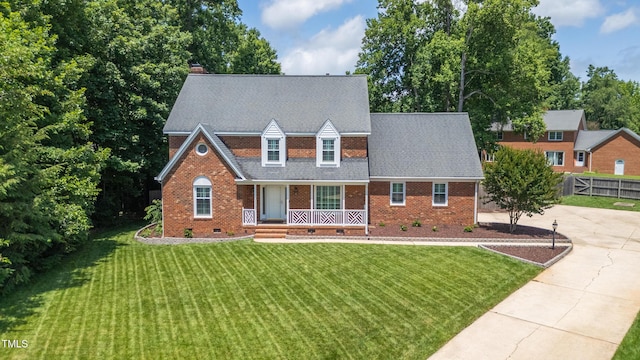 213 Brompton Ct, Burlington, NC 27215 - view of front of house featuring a porch, crawl space, brick siding, and a chimney