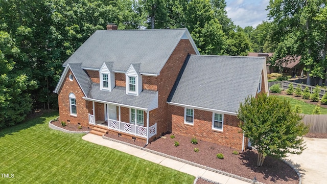 213 Brompton Ct, Burlington, NC 27215 - view of front facade with a porch, a chimney, brick siding, and roof with shingles