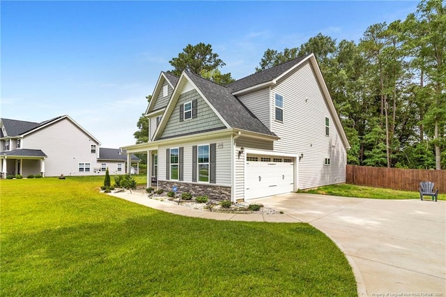6939 Running Fox Rd, Hope Mills, NC 28348 - view of front of property with concrete driveway, stone siding, an attached garage, and a shingled roof