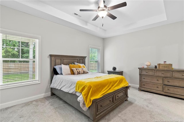 6939 Running Fox Rd, Hope Mills, NC 28348 - bedroom featuring light carpet, a tray ceiling, and a ceiling fan