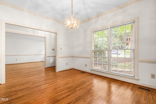 101 Turnberry Ln, Cary, NC 27511 - spare room featuring crown molding, a chandelier, and wood finished floors