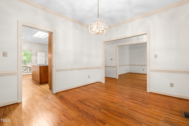 101 Turnberry Ln, Cary, NC 27511 - spare room with crown molding, wood finished floors, and a chandelier