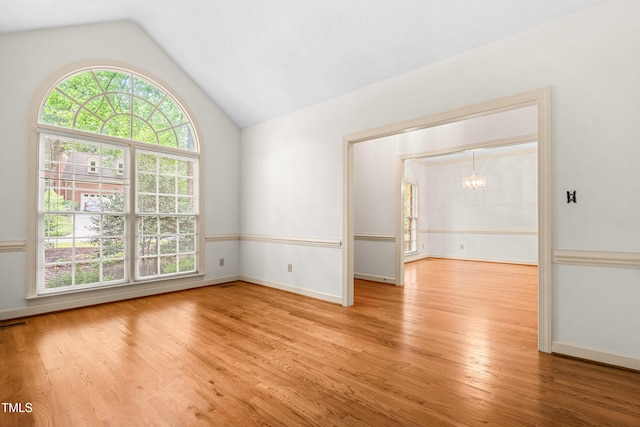 101 Turnberry Ln, Cary, NC 27511 - unfurnished room featuring a chandelier, wood finished floors, and lofted ceiling