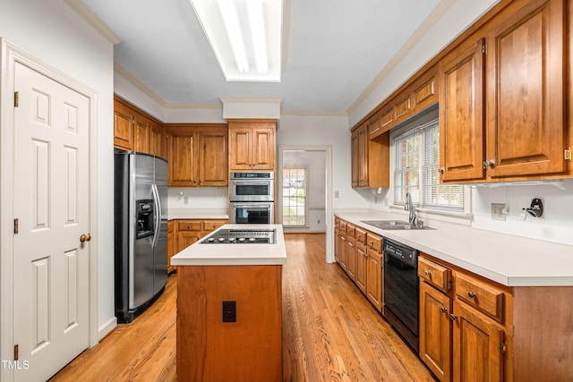 101 Turnberry Ln, Cary, NC 27511 - kitchen featuring appliances with stainless steel finishes, brown cabinetry, a center island, light wood-type flooring, and crown molding