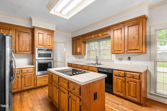 101 Turnberry Ln, Cary, NC 27511 - kitchen featuring stainless steel appliances, light wood finished floors, brown cabinets, and crown molding