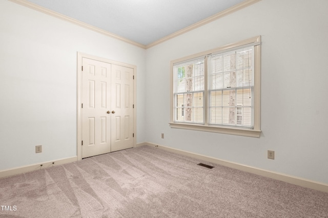 101 Turnberry Ln, Cary, NC 27511 - unfurnished bedroom featuring crown molding, carpet flooring, and a closet