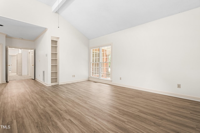 101 Turnberry Ln, Cary, NC 27511 - unfurnished living room featuring wood finished floors, beam ceiling, and high vaulted ceiling