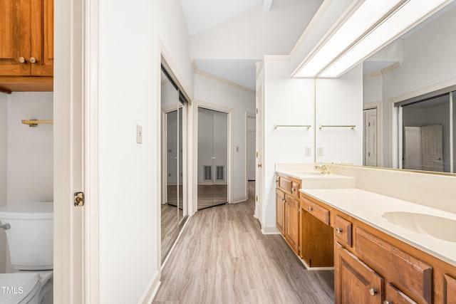101 Turnberry Ln, Cary, NC 27511 - full bath featuring double vanity, wood finished floors, and vaulted ceiling