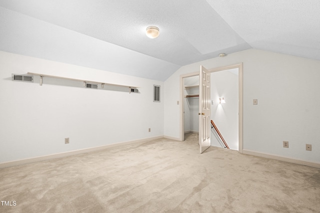 101 Turnberry Ln, Cary, NC 27511 - bonus room featuring lofted ceiling, carpet floors, and a textured ceiling