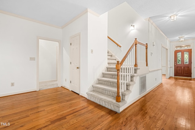 101 Turnberry Ln, Cary, NC 27511 - foyer entrance featuring crown molding, wood finished floors, and stairway