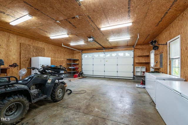 901 Tamaras Cir, Wake Forest, NC 27587 - garage featuring freestanding refrigerator, fridge, electric panel, and a garage door opener