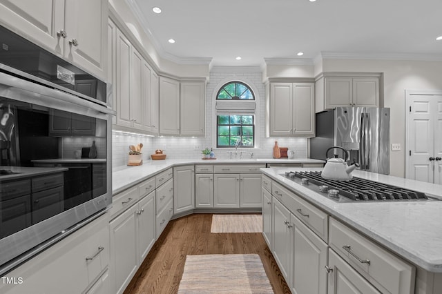901 Tamaras Cir, Wake Forest, NC 27587 - kitchen featuring stainless steel appliances, ornamental molding, dark wood-style flooring, white cabinets, and recessed lighting