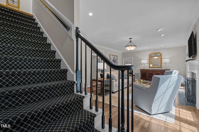 901 Tamaras Cir, Wake Forest, NC 27587 - staircase with wood finished floors, crown molding, and recessed lighting
