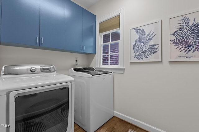 901 Tamaras Cir, Wake Forest, NC 27587 - laundry area featuring cabinet space, washer and clothes dryer, and wood finished floors