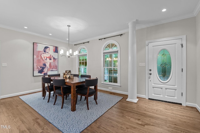 901 Tamaras Cir, Wake Forest, NC 27587 - dining space featuring ornate columns, wood finished floors, recessed lighting, crown molding, and a chandelier