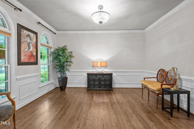 901 Tamaras Cir, Wake Forest, NC 27587 - living area with ornamental molding, wood finished floors, a chandelier, and wainscoting