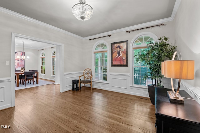 901 Tamaras Cir, Wake Forest, NC 27587 - entrance foyer featuring a chandelier, wood finished floors, crown molding, a wainscoted wall, and a decorative wall