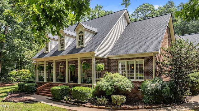 901 Tamaras Cir, Wake Forest, NC 27587 - view of front of house featuring a porch, brick siding, and a shingled roof
