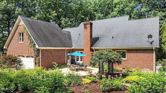 901 Tamaras Cir, Wake Forest, NC 27587 - back of house with brick siding, crawl space, roof with shingles, and a patio area