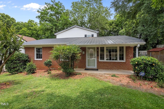 110 Starlite Dr, Carrboro, NC 27510 - view of front of property with a front lawn, brick siding, a metal roof, and a porch
