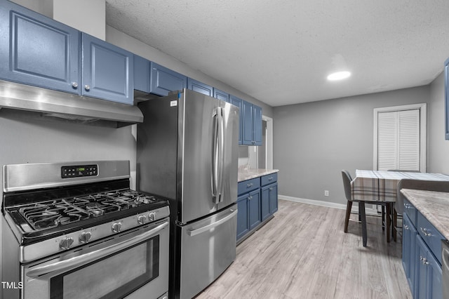 110 Starlite Dr, Carrboro, NC 27510 - kitchen featuring stainless steel appliances, blue cabinets, under cabinet range hood, light wood-style flooring, and a textured ceiling