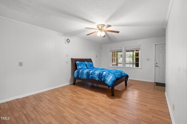 110 Starlite Dr, Carrboro, NC 27510 - bedroom featuring light wood-style flooring, a textured ceiling, ornamental molding, and a ceiling fan