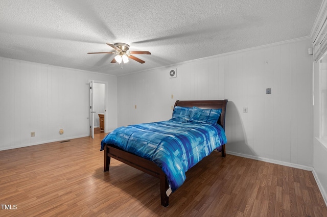 110 Starlite Dr, Carrboro, NC 27510 - bedroom with wood finished floors, a textured ceiling, and a ceiling fan