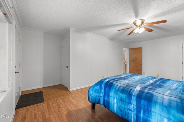 110 Starlite Dr, Carrboro, NC 27510 - bedroom with light wood-style flooring, a textured ceiling, ceiling fan, and ornamental molding