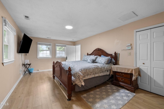 110 Starlite Dr, Carrboro, NC 27510 - bedroom featuring light wood-type flooring and a textured ceiling