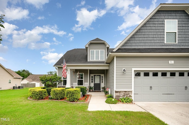 71 Sanibel St, Clayton, NC 27520 - view of front of property with a front yard, concrete driveway, and stone siding