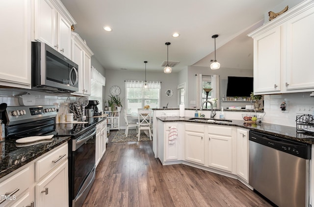 71 Sanibel St, Clayton, NC 27520 - kitchen with appliances with stainless steel finishes, tasteful backsplash, a peninsula, white cabinetry, and recessed lighting