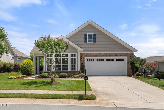 102 Mikaila Dr, Gibsonville, NC 27249 - traditional-style home with concrete driveway, a garage, and stone siding