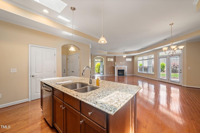 102 Mikaila Dr, Gibsonville, NC 27249 - kitchen with a raised ceiling, crown molding, dishwasher, arched walkways, and a tile fireplace
