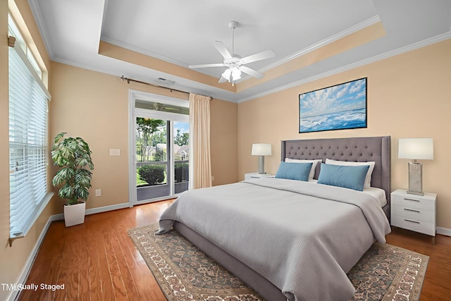 102 Mikaila Dr, Gibsonville, NC 27249 - bedroom with a raised ceiling, access to exterior, crown molding, wood finished floors, and a ceiling fan