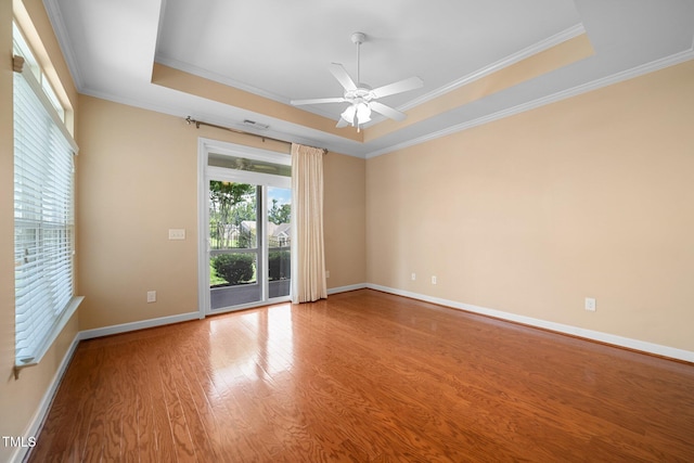 102 Mikaila Dr, Gibsonville, NC 27249 - unfurnished room featuring a raised ceiling, crown molding, wood finished floors, and a ceiling fan