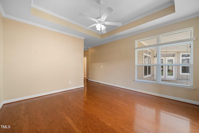 102 Mikaila Dr, Gibsonville, NC 27249 - spare room featuring wood finished floors, crown molding, a tray ceiling, and a ceiling fan