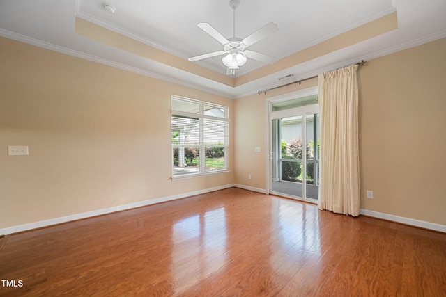 102 Mikaila Dr, Gibsonville, NC 27249 - unfurnished room featuring a tray ceiling, ornamental molding, wood finished floors, a smoke detector, and ceiling fan