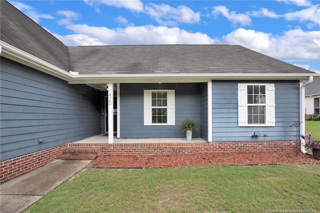 420 Gibson Dr, Raeford, NC 28376 - doorway to property featuring covered porch, a yard, and a shingled roof