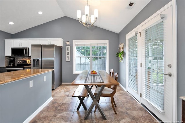 420 Gibson Dr, Raeford, NC 28376 - dining room with a chandelier, vaulted ceiling, recessed lighting, and light stone finish floors
