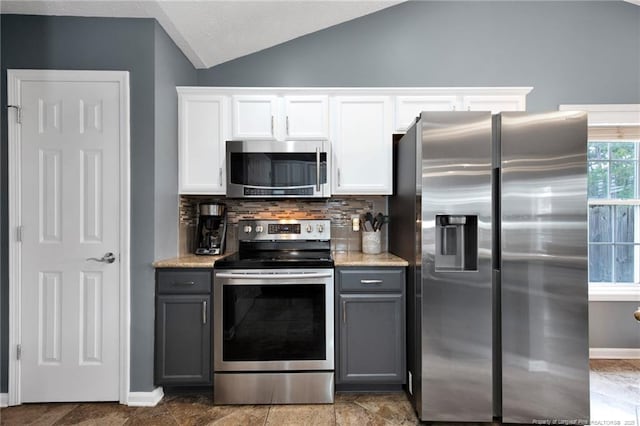 420 Gibson Dr, Raeford, NC 28376 - kitchen featuring appliances with stainless steel finishes, lofted ceiling, backsplash, gray cabinetry, and white cabinetry