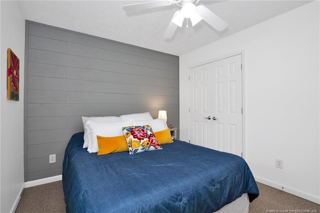 420 Gibson Dr, Raeford, NC 28376 - bedroom with carpet flooring, a ceiling fan, a closet, and wood walls
