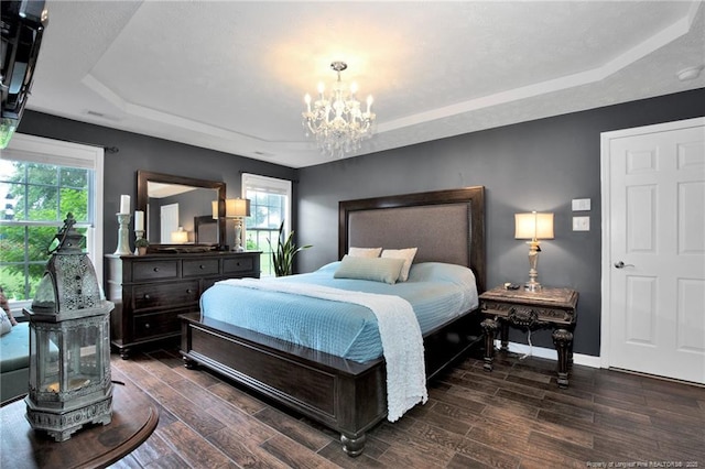 420 Gibson Dr, Raeford, NC 28376 - bedroom featuring a raised ceiling, a chandelier, dark wood finished floors, and multiple windows