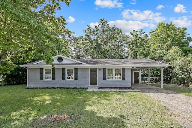2304 Electra Rd, Fayetteville, NC 28304 - view of front facade with gravel driveway, brick siding, a front lawn, and an attached carport