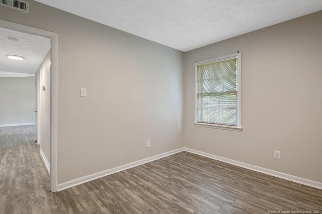2304 Electra Rd, Fayetteville, NC 28304 - spare room featuring dark wood-style floors and a textured ceiling