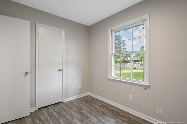 2304 Electra Rd, Fayetteville, NC 28304 - unfurnished bedroom featuring dark wood-style floors and multiple windows