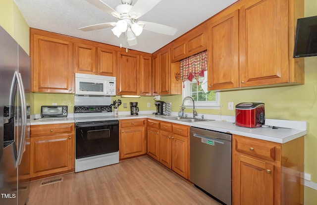 6408 Glen Brack Ct, Raleigh, NC 27603 - kitchen with stainless steel appliances, light wood finished floors, light countertops, and a ceiling fan